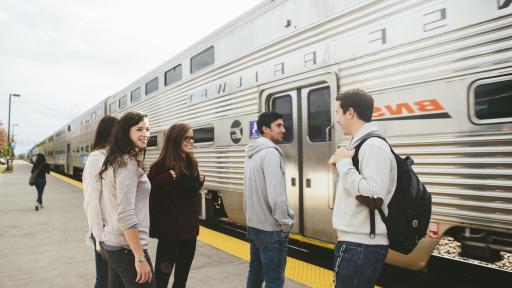 students by the train station